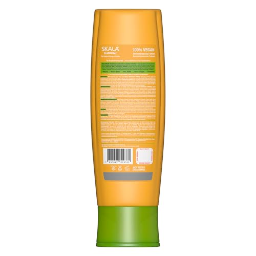 Applying SKALA Banana Conditioner to strands for smoother, manageable hair