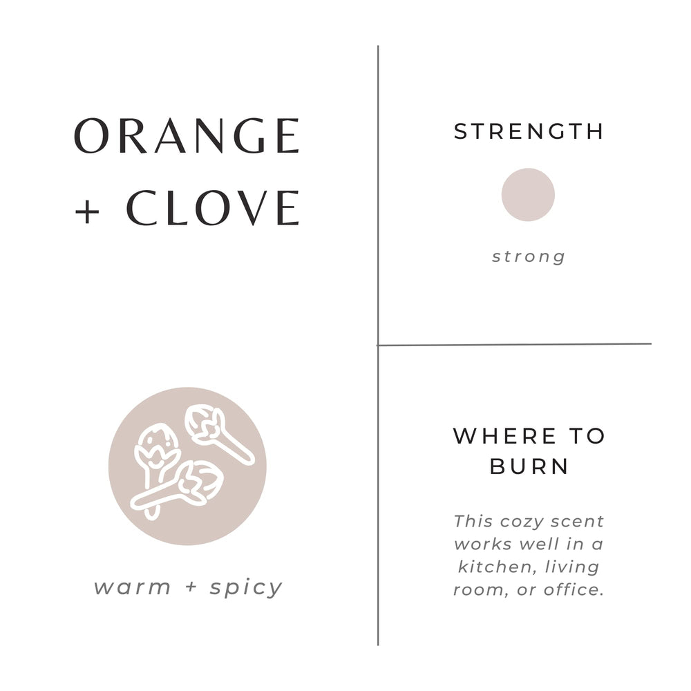Slow North Orange + Clove Candle lit with warm glow