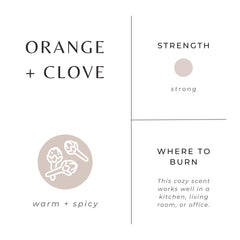 Slow North Orange + Clove Candle lit with warm glow