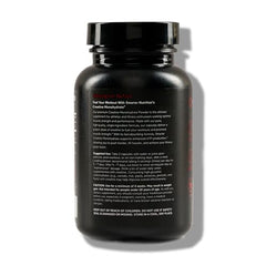 Close-up of creatine monohydrate pills and bottle