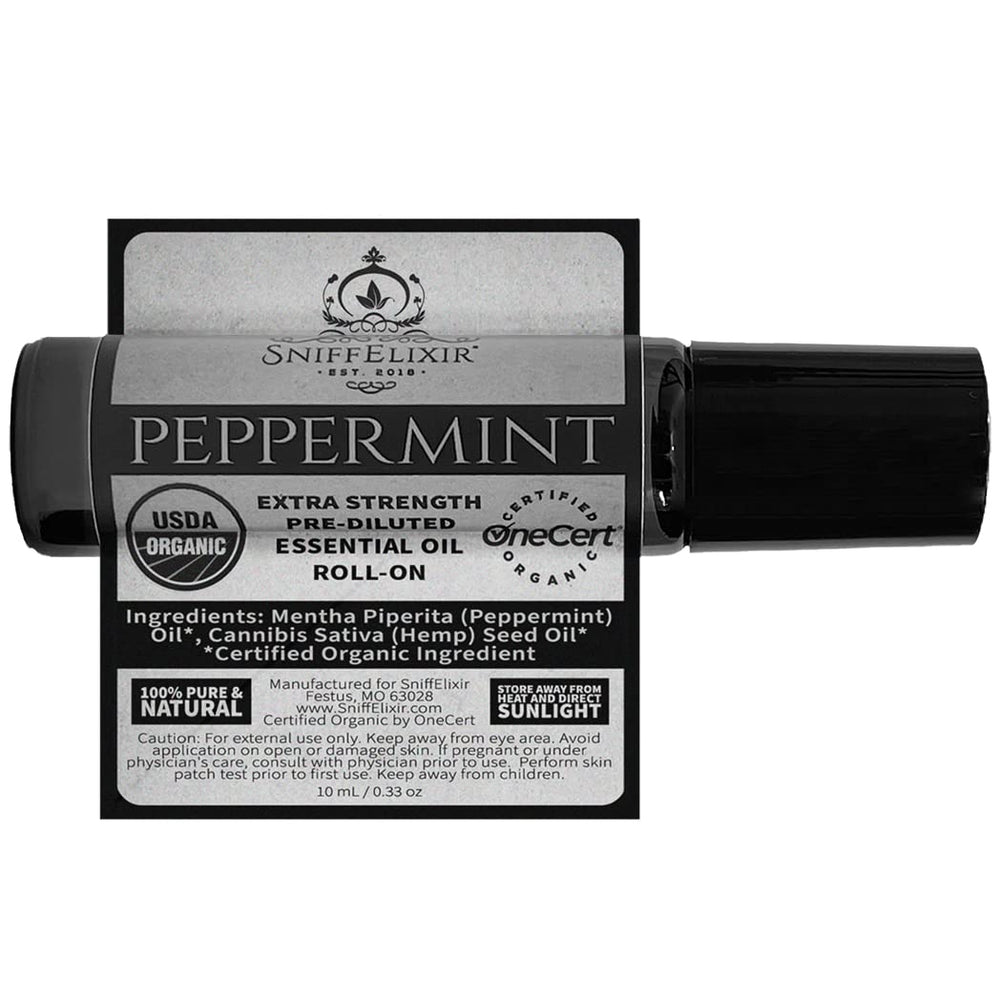 Travel-size Sniffelixir peppermint roll-on beside skincare products