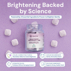 Close-up of biting a SNOW whitening toothpaste tablet