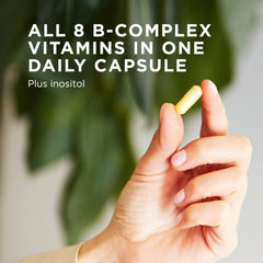 Solgar B-Complex 100 capsules spilled on a white surface