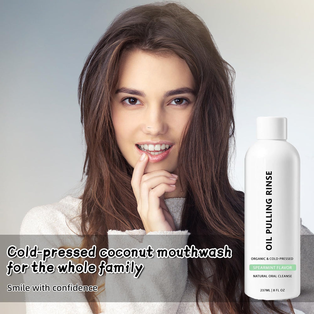 Measuring spoon with Spearmint Oil Pulling Rinse falling into mouth