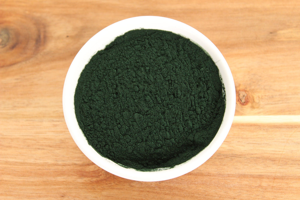 Spirulina powder being added to smoothies and desserts
