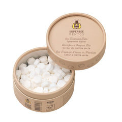 Chewing a SuperBee Dentos toothpaste tablet to form paste