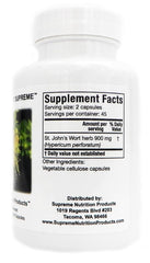 Supreme Nutrition capsules in hand beside a glass of water, showing daily routine convenience