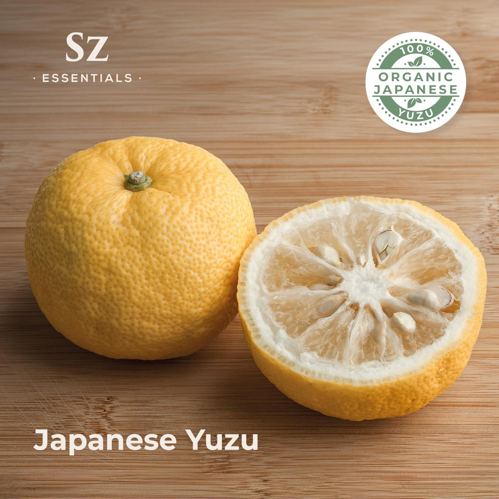 Yuzu fruit peels and essential oil bottle