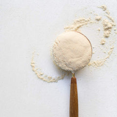 Maca powder being added to smoothie