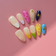 Tesytto nails with 3D floral and polka-dot accents for playful elegance.