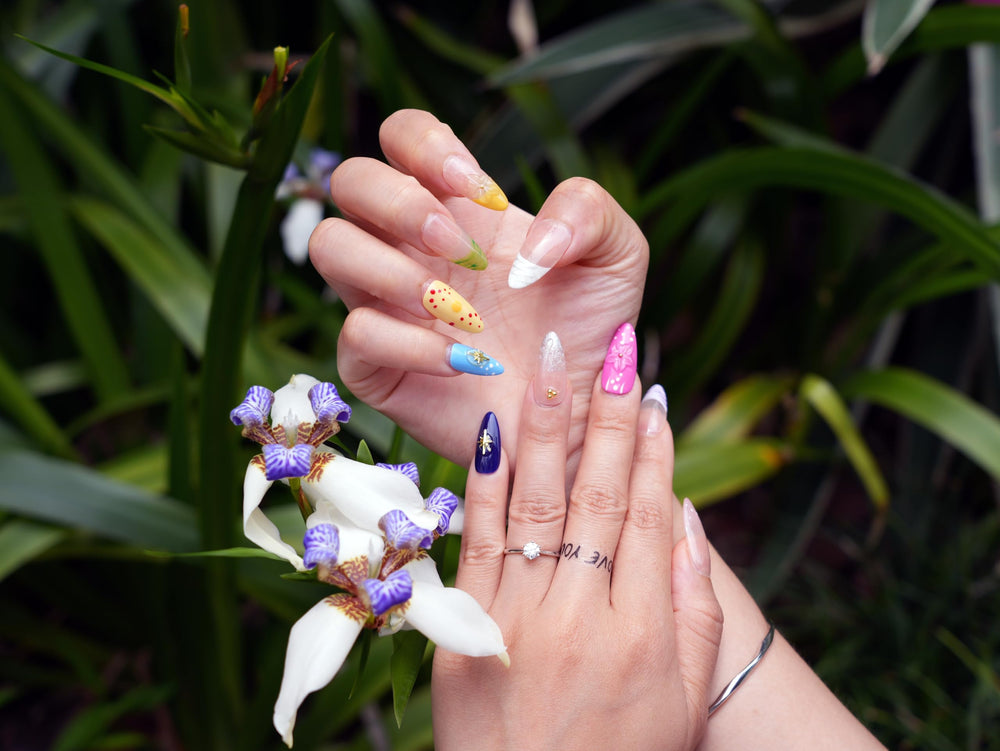 Tesytto pastel multi-color nails with swirl design for fresh, trendy style.