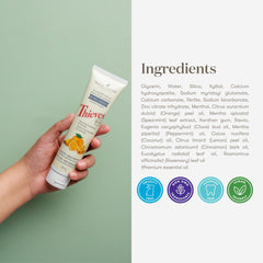 Toothpaste on a toothbrush with mint leaves