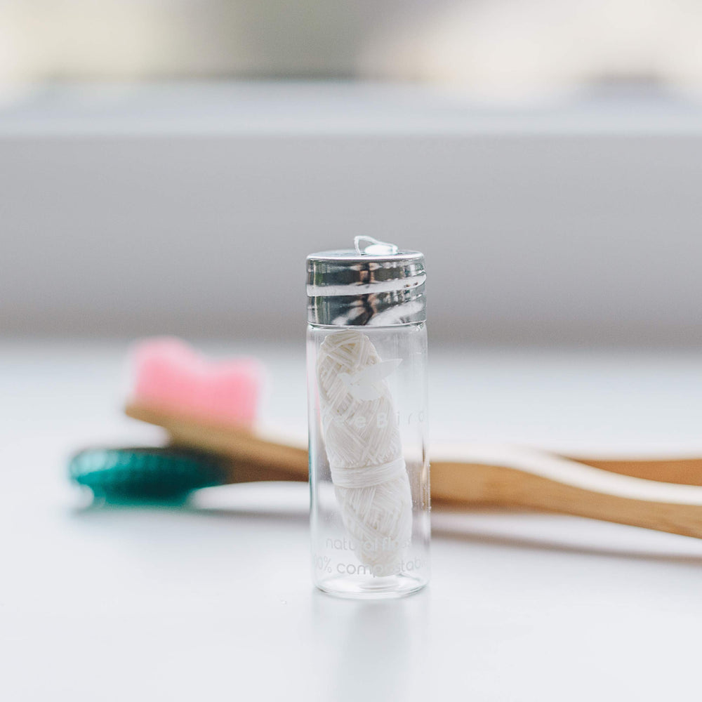 Refillable clear glass dispenser with metal cap and built-in cutter