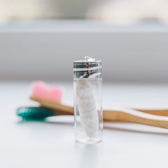 Refillable clear glass dispenser with metal cap and built-in cutter