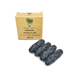 Front view of vegan bamboo charcoal dental floss refill four-pack