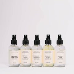 4 fl oz room spray bottle resting on a white surface