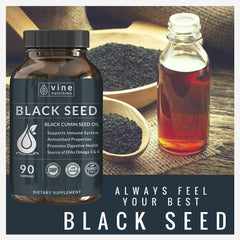 Several black seed oil capsules with natural background