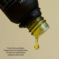 Drops of orange essential oil from a dropper
