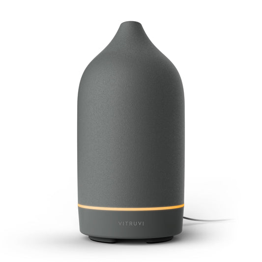 Vitruvi Stone Ceramic Ultrasonic Diffuser on a bedside table