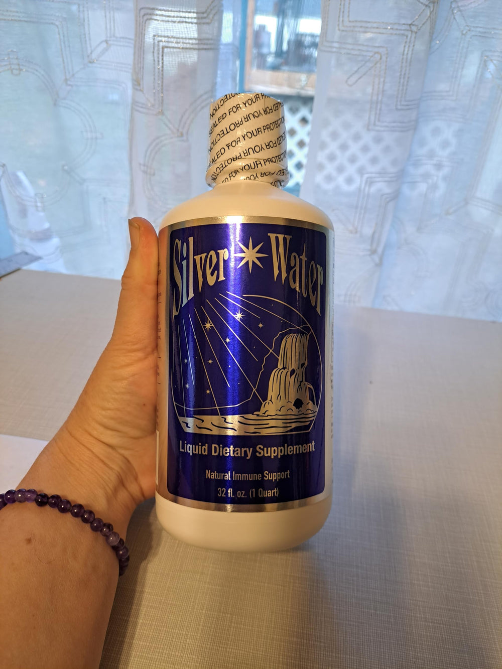 Close-up of the '99.999 Pure Silver Distilled Water' label