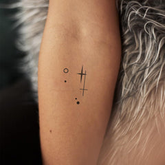 WEEKINK Libra glyph tattoo closeup with intricate lines.
