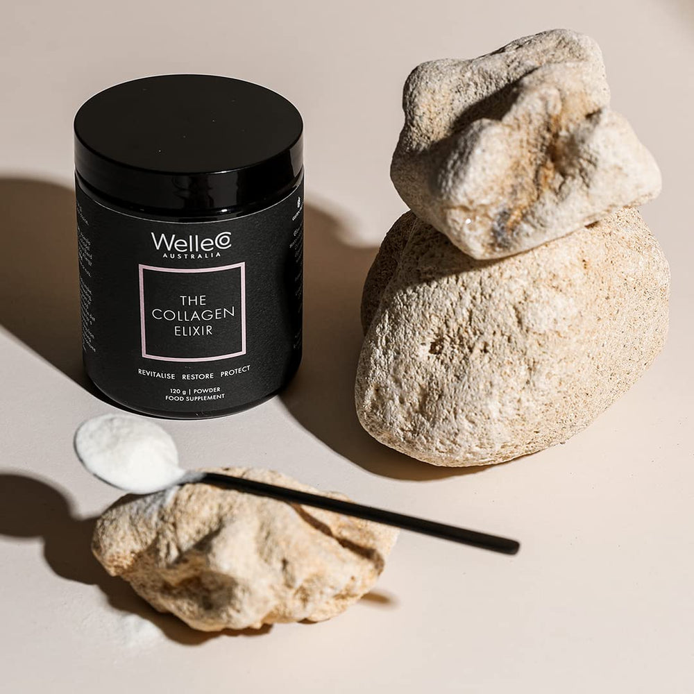 Measuring two teaspoons of WelleCo Collagen Elixir for daily use
