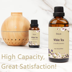 Close-up of White Tea Essential Oil bottle with amber glass