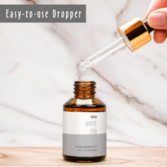 Scented oil packaging and bottle on clean surface