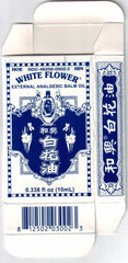 Lifestyle shot of White Flower Balm Oil on a clean surface