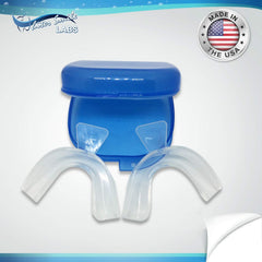 Upper and lower whitening trays fitted around teeth