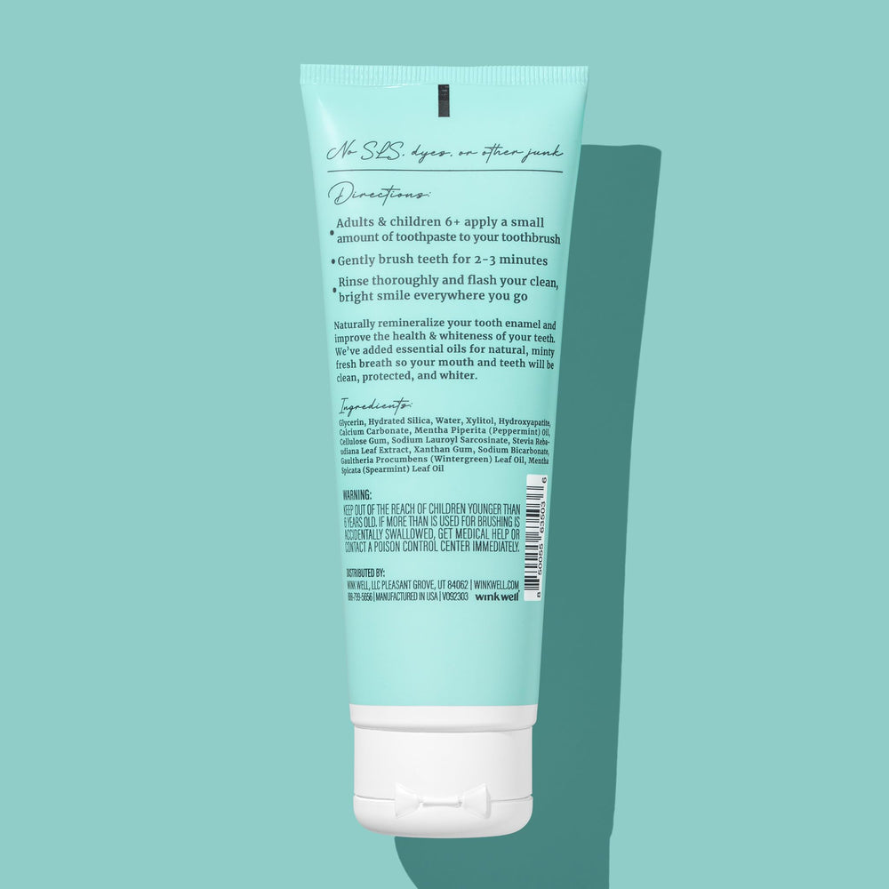 Close-up of Wink Well toothpaste tube with mint flavor