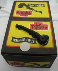 Close-up of black licorice pipes in display