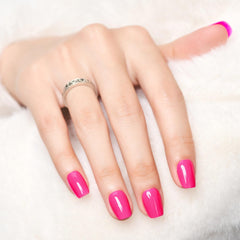Wooyas neon pink nails shown on finger for lightweight wear.