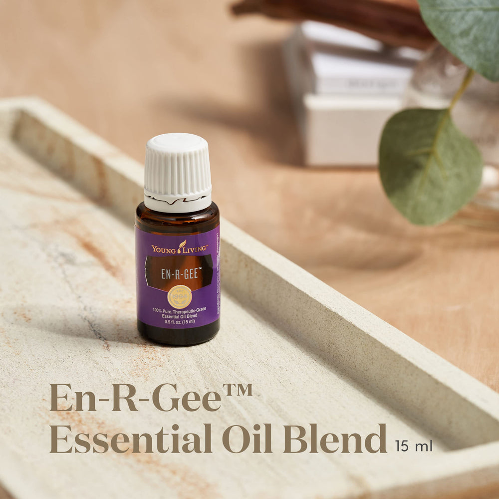 Young Living En-R-Gee bottle with drops beside a diffuser for daytime focus.