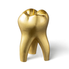 Gold tooth-shaped candle design