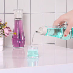 Close-up of glass bottle with cap and built-in cup