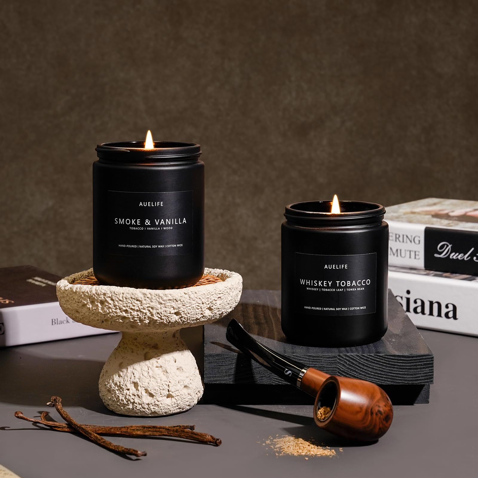 Two candles displayed in a masculine home decor setup