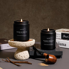Two candles displayed in a masculine home decor setup