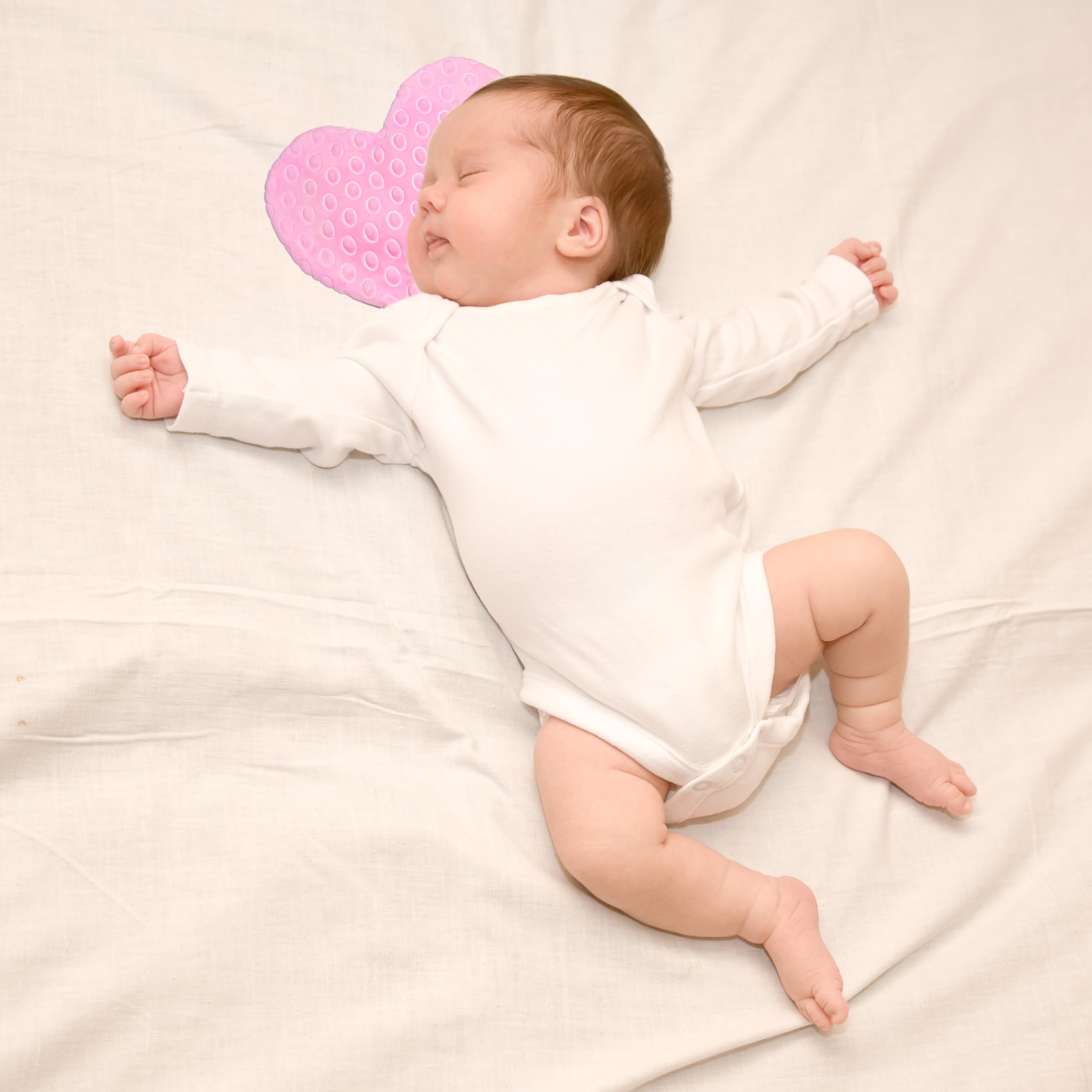NICU baby with scent bonding pad worn close to caregiver's chest