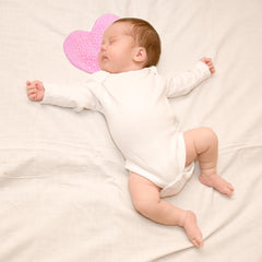 NICU baby with scent bonding pad worn close to caregiver's chest