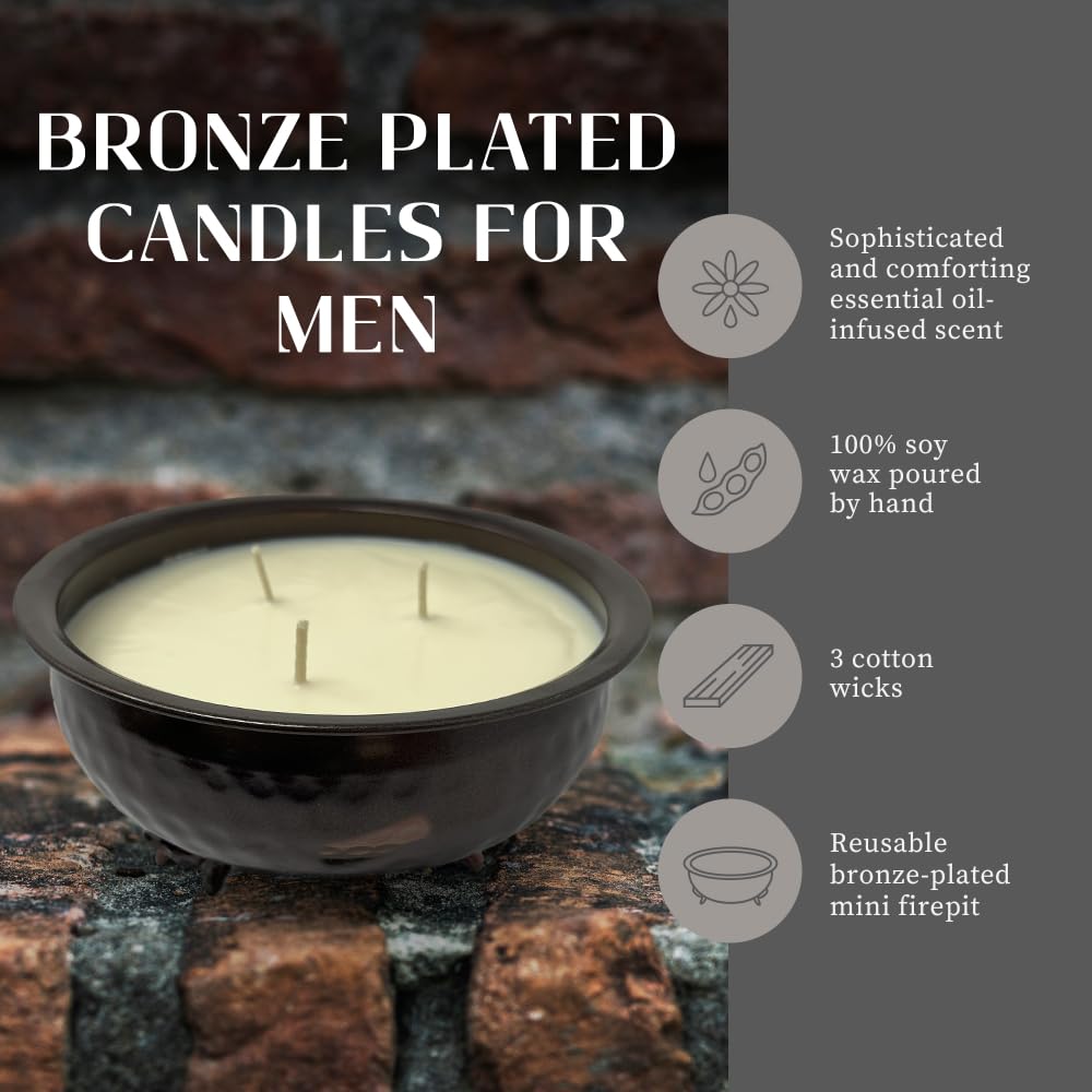 Three-wick candle burning in a bronze container for masculine room decor.