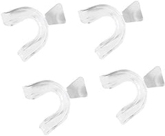Set of four transparent silicone mouth guards laid out