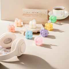 Pastel soft yellow bubble-shaped mini soy candle in frosted jar