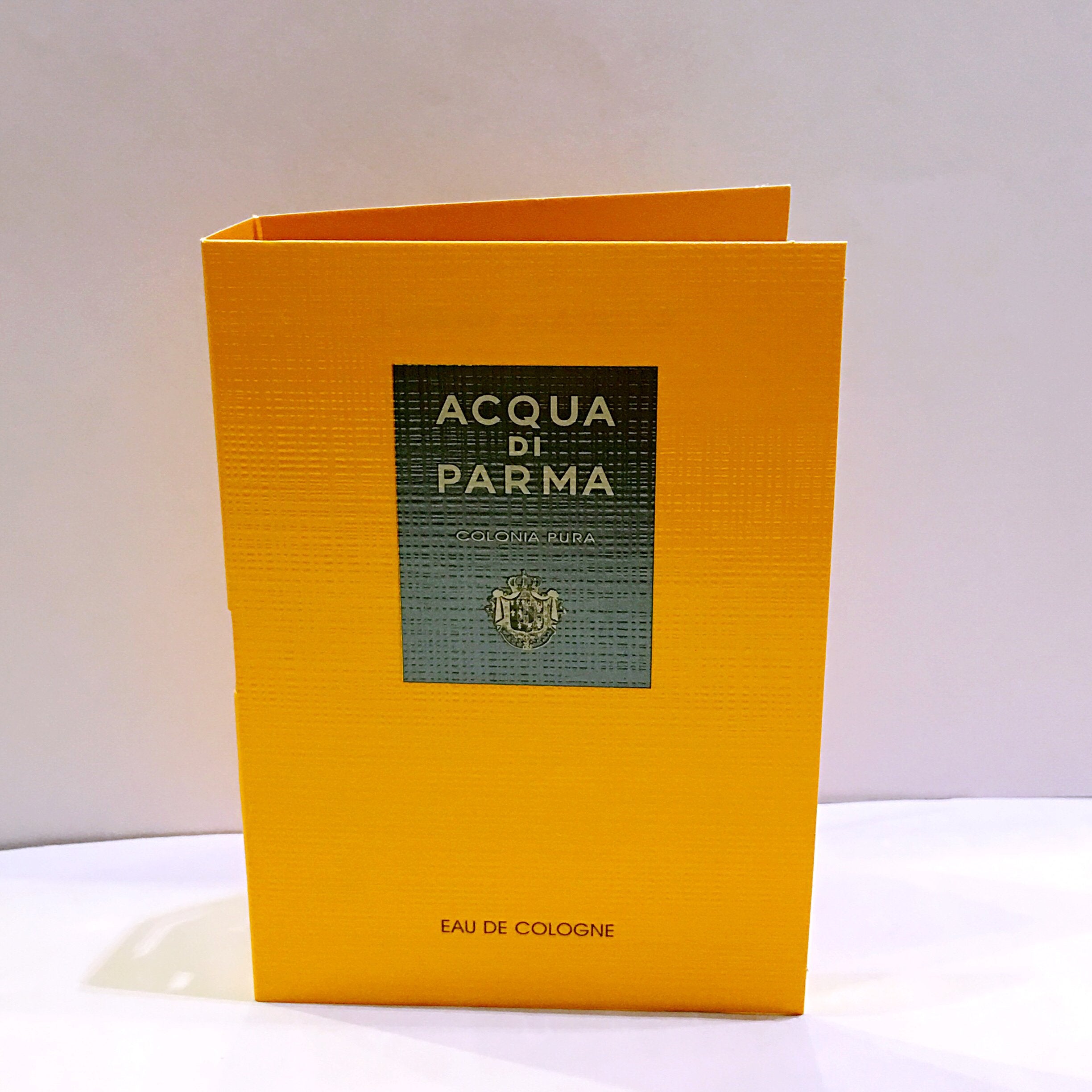 Acqua di Parma Colonia Pura bottle being poured, highlighting fresh citrus notes for everyday freshness.