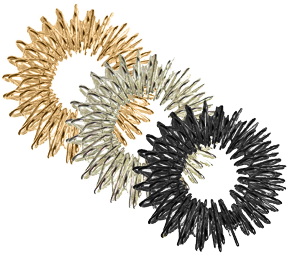 Three acupressure massage rings in gold, silver, and black