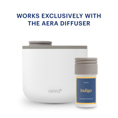 Aera Mini Indigo capsule next to smartphone for compact size and portability
