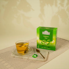 Green tea being brewed in a cup