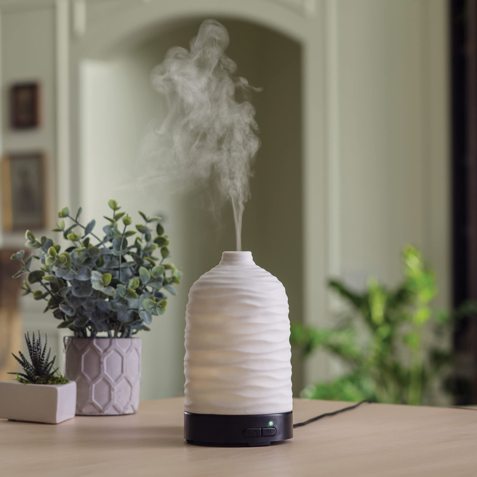 Airome Harmony diffuser in use with intermittent and continual mist settings