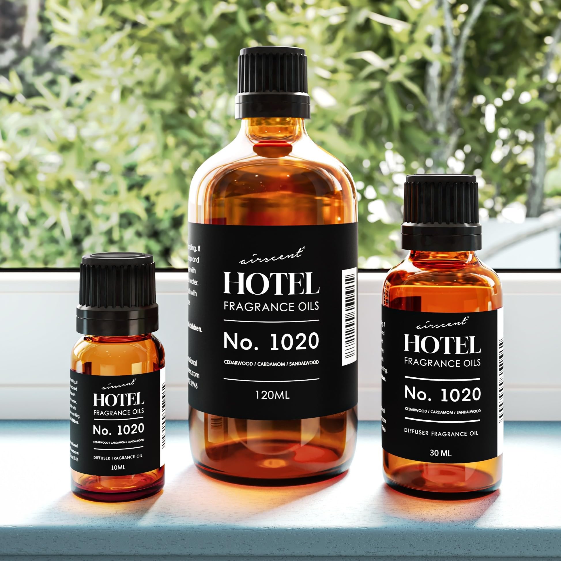 Bottled diffuser oil 1020 Bergamot Cardamom Sandalwood on glass surface