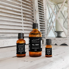 Open bottle of AirScent Oud Wood Diffuser Oil No. 5005 showing glass dropper